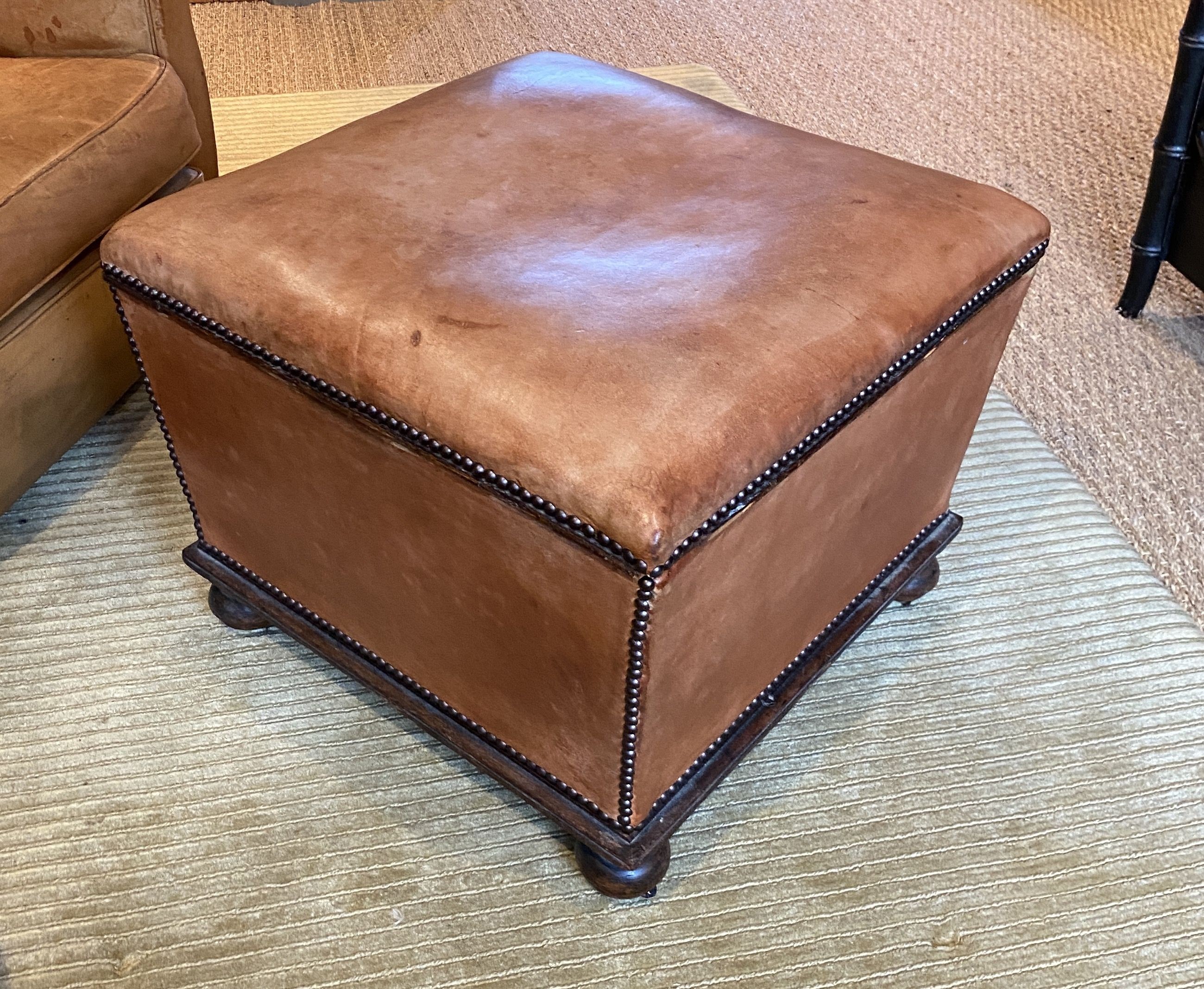 A Victorian mahogany ottoman, later upholstered in pale tan leather, width 57cm depth 55cm height 44cm